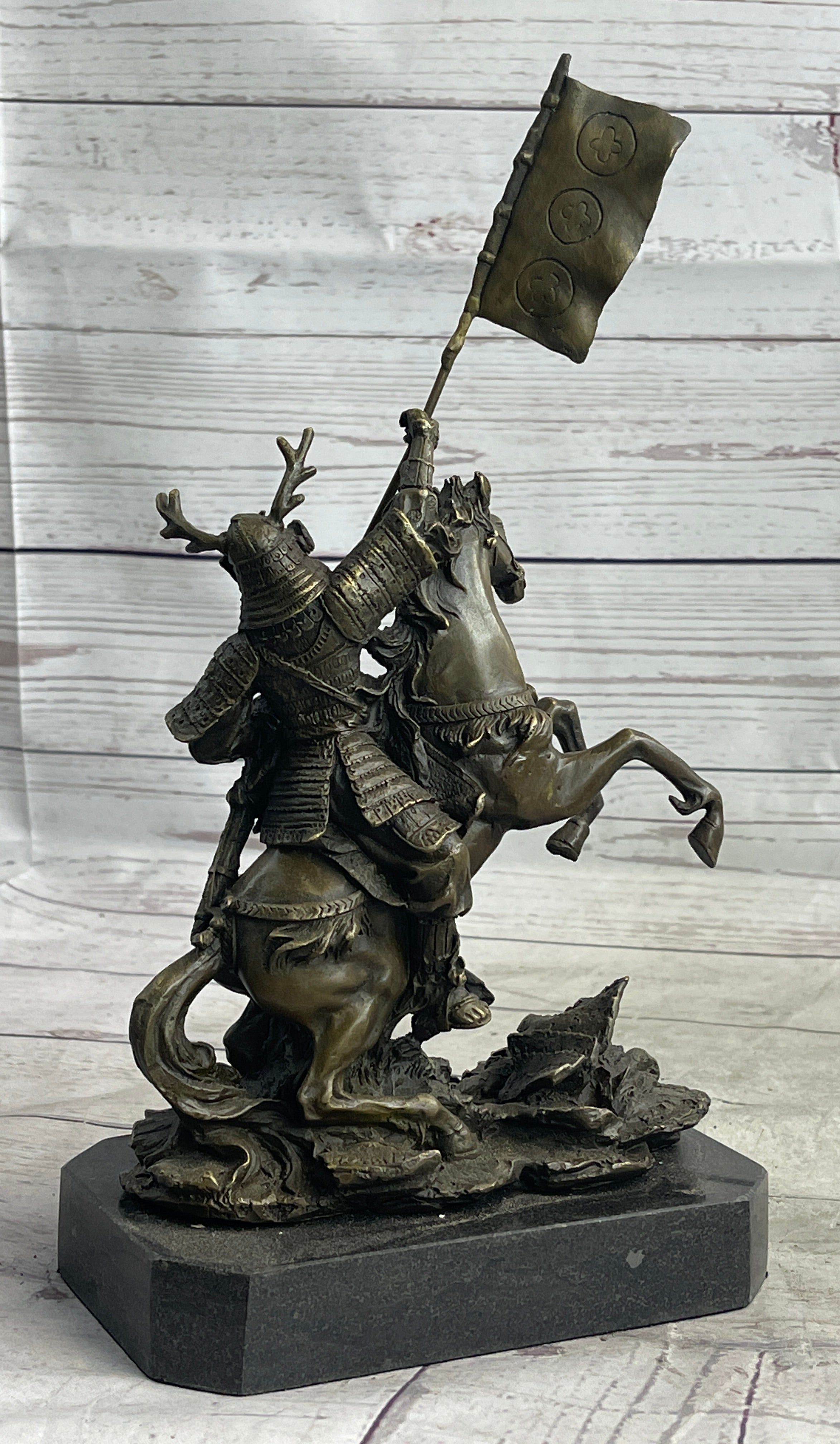 A Mongolian brass figurine of a warrior on horseback with