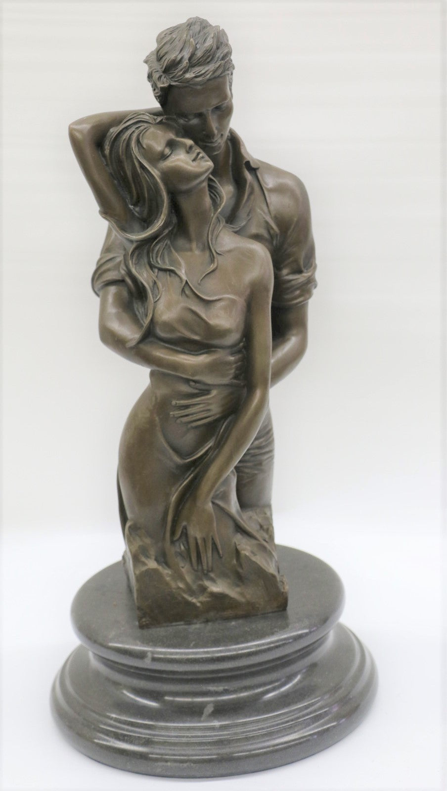 Bronze sculpture of a couple`s tender embrace portrays the power of intimacy